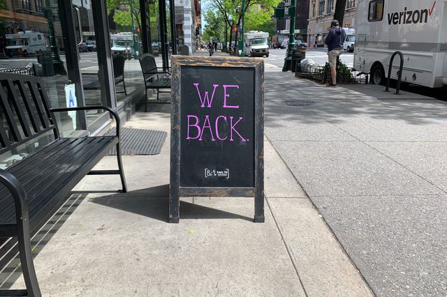 A sign outside an Upper WEst Side coffee shop says "We Back"